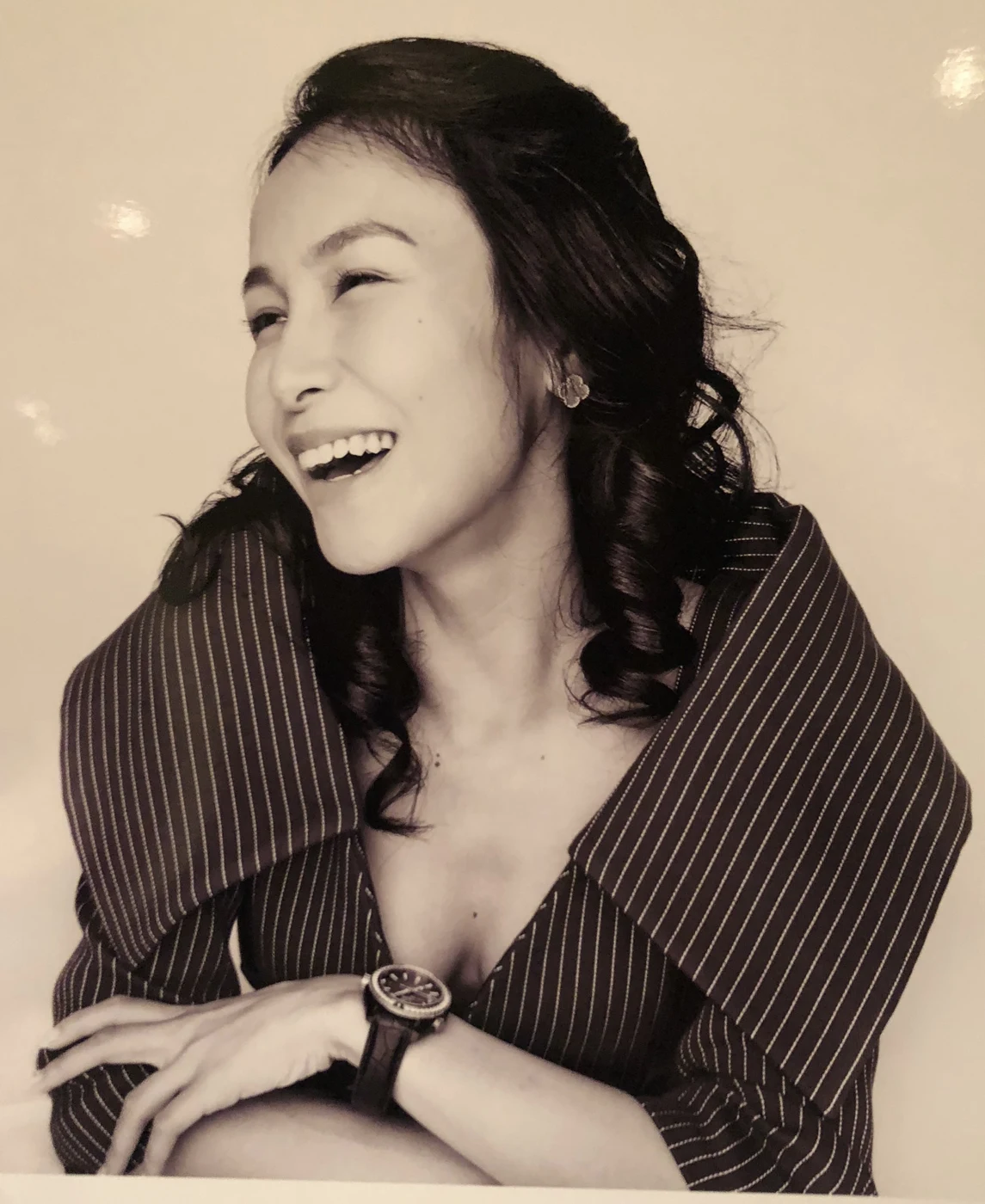Chelsea laughing in a sepia portrait