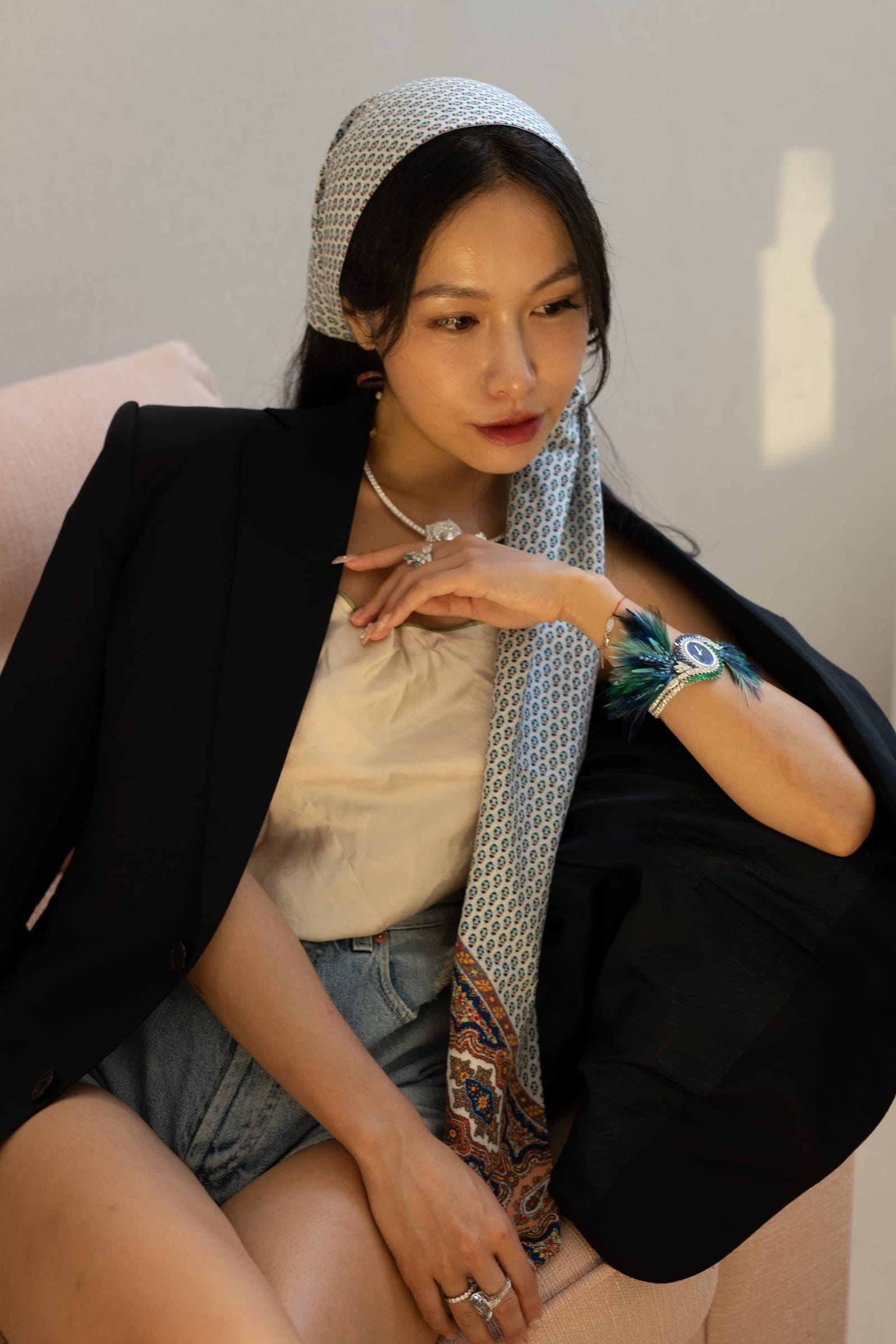 Chelsea seated, showing her jewellery and watch