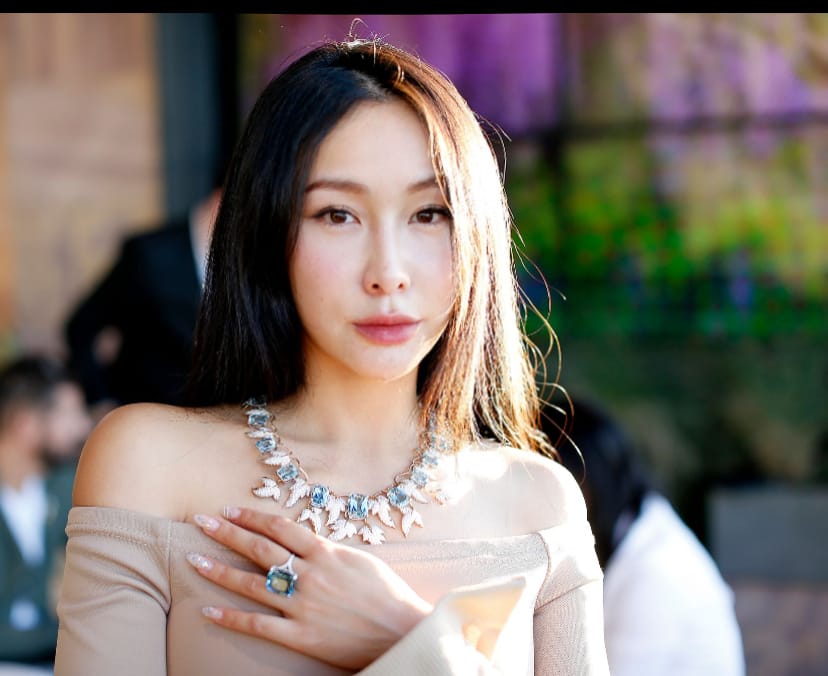 Chelsea wearing a necklace and ring