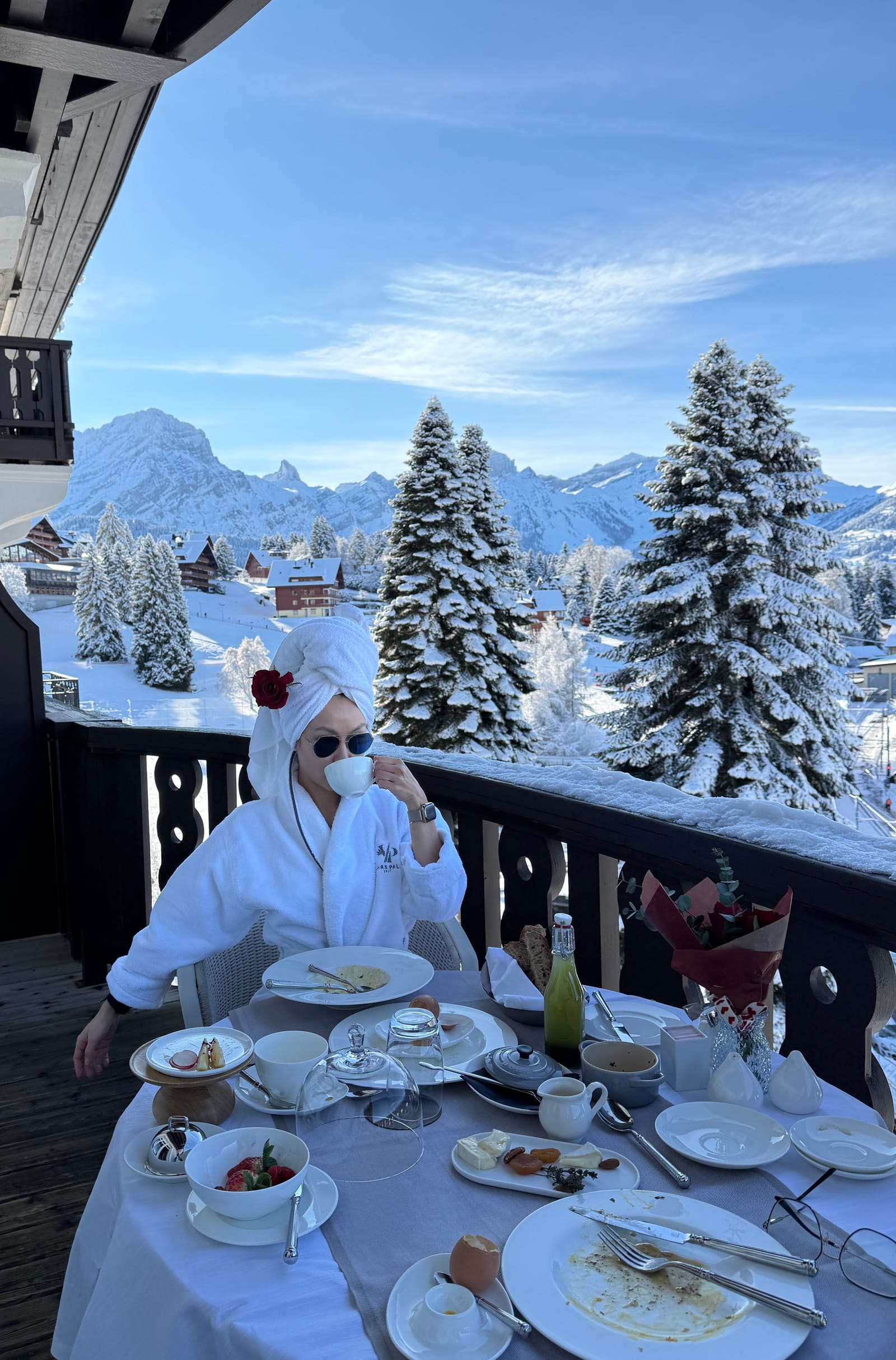 Chelsea at breakfast on a snowy mountain terrace