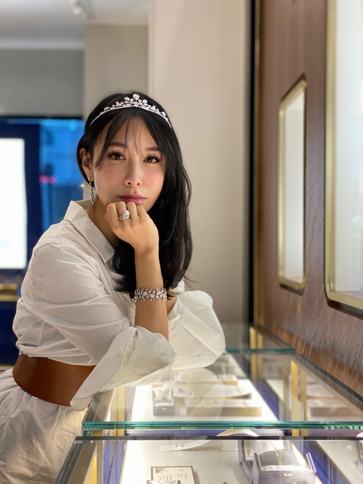 Chelsea wearing a tiara beside a jewellery display